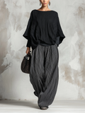 Conjunto negro de top plisado estilo murciélago y pantalón ancho