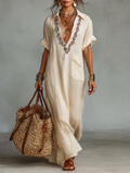 Vestido maxi de lino con escote en V bordado y detalles de bolsillos