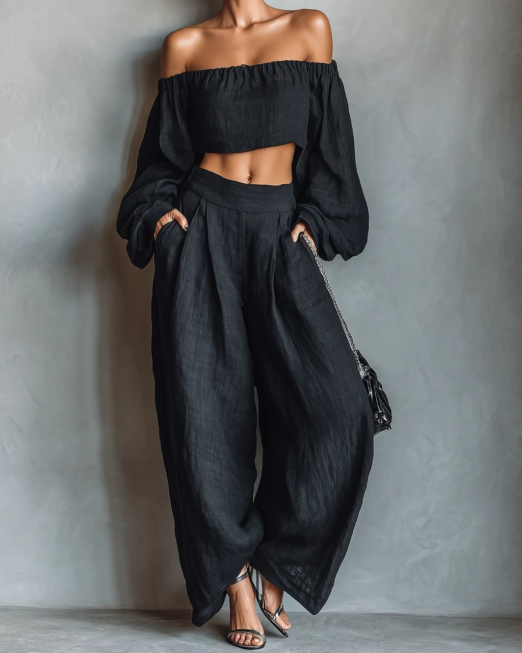 Conjunto negro de top con hombros descubiertos y pantalón ancho
