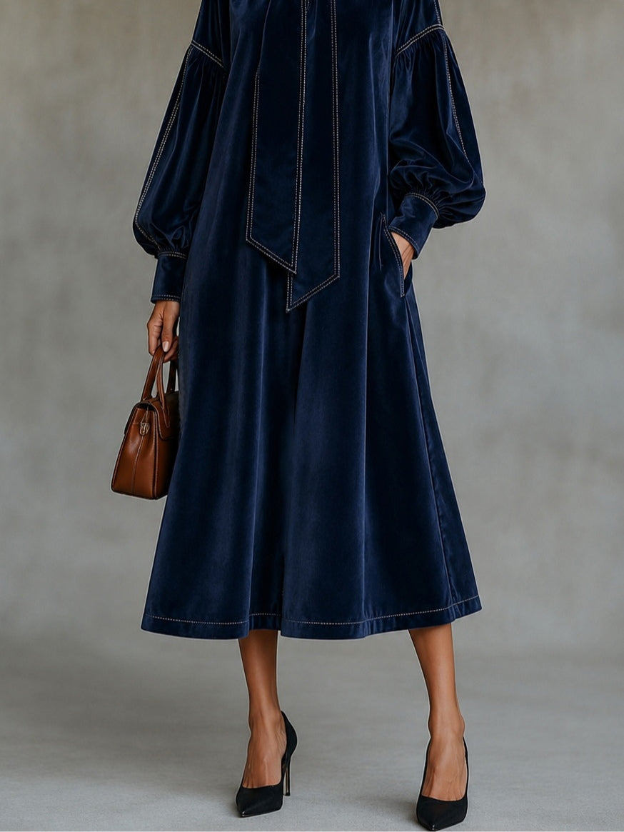 Vestido midi de terciopelo azul marino con lazo y mangas abullonadas